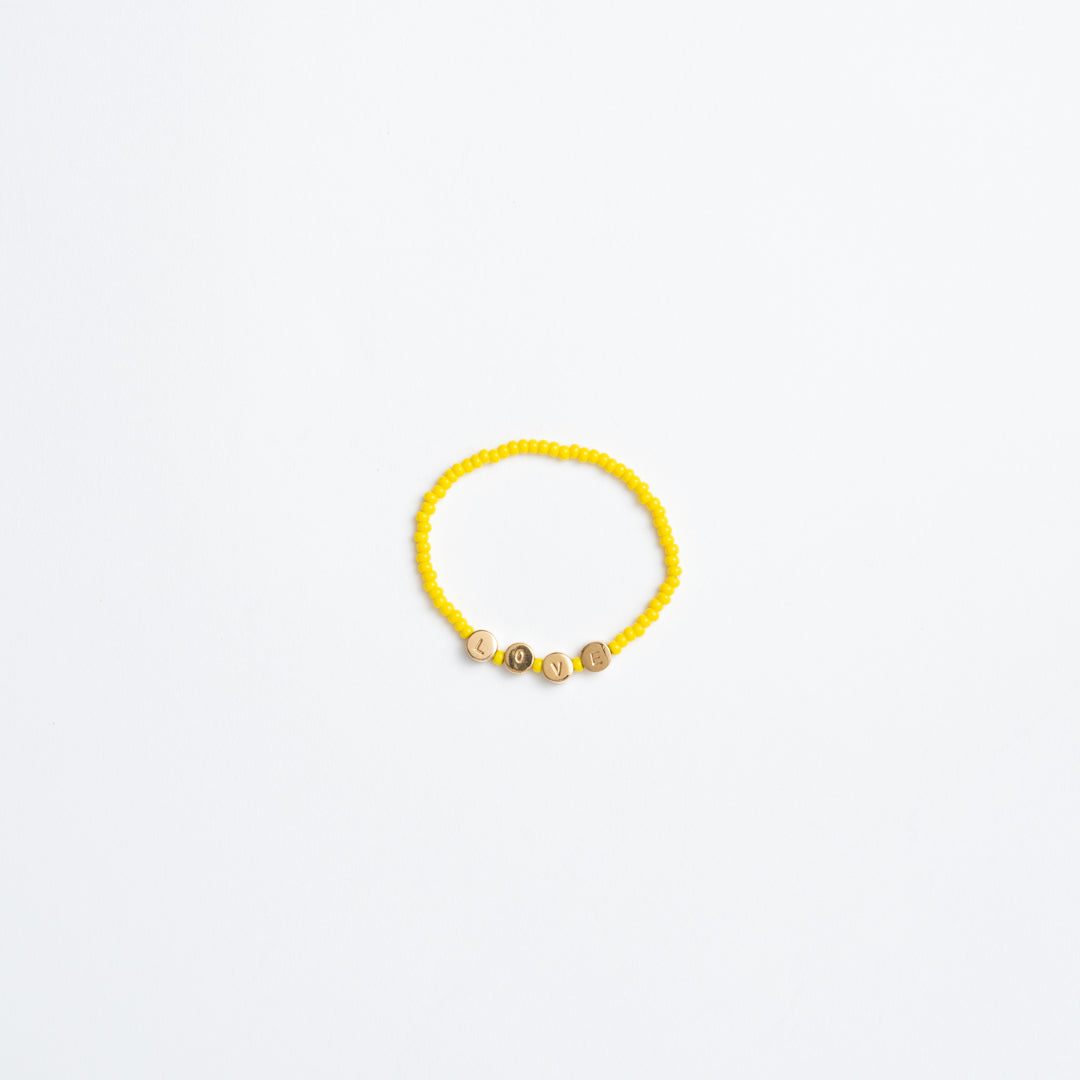 FINAL SALE: Elastic Bracelet with Round Brass LOVE Beads - Marigold